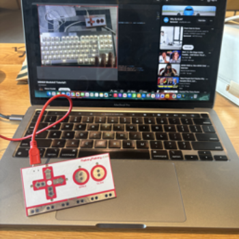 Makey Makey connected to computer while watching tutorials.